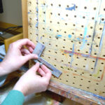 Use hardware to attach the brackets to pegboard